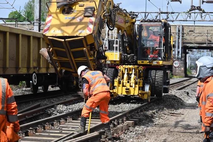 Plant machinery laying new ballast stone.