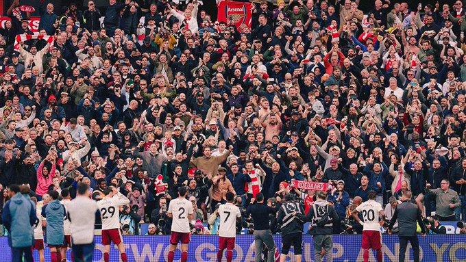Arsenal squad celebrate with their supporters at full-time