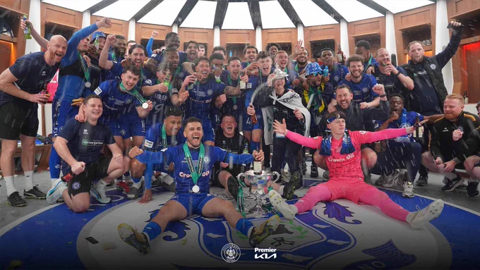 Football players celebrating at Wembley Stadium