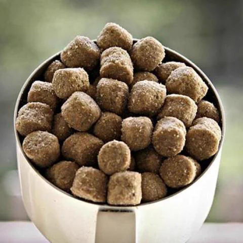 A scoop full of pet food kibble