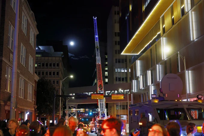 Emergency responders from around the Richmond region participate in the fourth annual goodnight lights event outside Children's Hospital of Richmond at VCU, by sounding their sirens and flashing their lights for fifteen minutes as a sign of support for the young patients inside. Here, firefighters from Henrico climb the ladder with the mood visible in the distance.