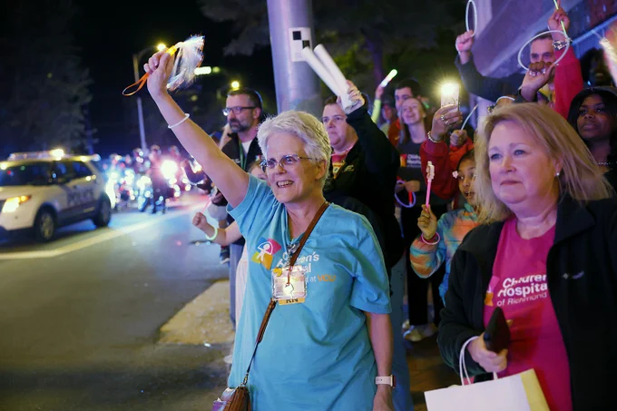 People gather to participate in the fourth annual goodnight lights event outside Children's Hospital of Richmond at VCU. Emergency responders from around the region were present, sounding their sirens and flashing their lights for fifteen minutes as a sign of support for the young patients inside. 