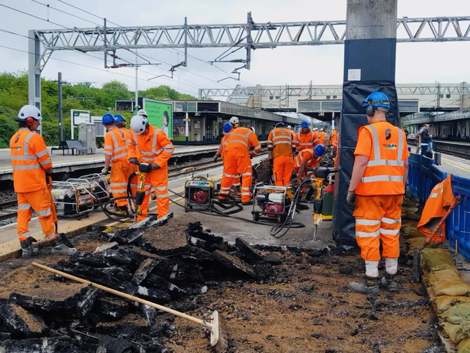 Contractor teams renewing the platform surface of Platform 4 at Milton Keynes Central station, pictured removing the old surface with jackhammers.