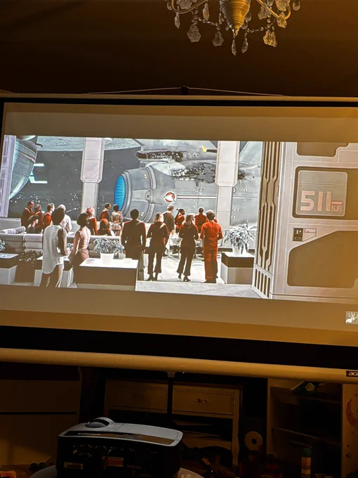 A shot of the USS Enterprise arriving at Spacedock from Star Trek III on a projector screen in my lounge