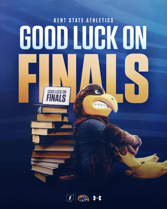 Flash the Golden Eagle representing Kent State Athletics and the Kent State Golden Flashes sits beside a large stack of books. A sign on the books reads, "Good Luck on Finals." The backdrop is a blue gradient with the text "Good Luck on Finals" prominently displayed. Kent State and Under Armour logos are also visible.