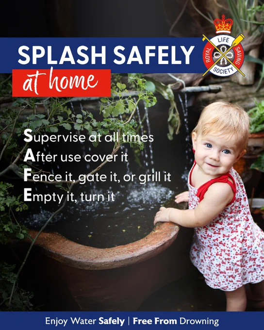 A young child stands by a large water feature, touching the water gently. The image features the Royal Life Saving Society logo. Text reads "SPLASH SAFELY at home" and provides water safety tips using the acronym SAFE: Supervise at all times, After use cover it, Fence it, gate it, or grill it, Empty it, turn it. The bottom text reads "Enjoy Water Safely | Free From Drowning.