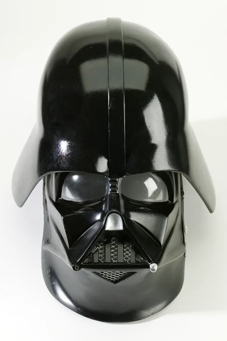 A black Darth Vader helmet from Star Wars is shown against a white background.
