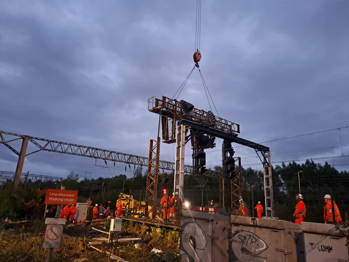 A photo of ongoing work to renew railway signalling equipment in Edge Hill as part of Network Rail’s Spring Rail Works - in the photo you can see an old structure being lifted out, with rail engineers directing the work