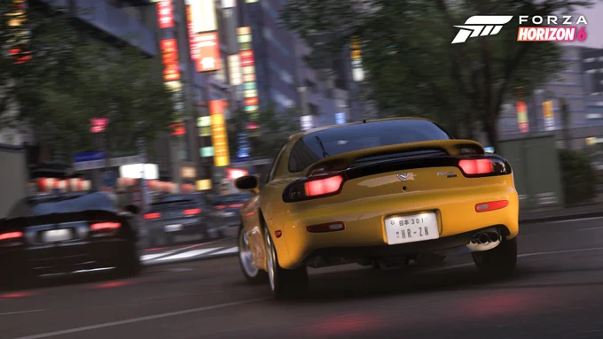 A yellow sports car speeds through a city street at night in a scene from the game "Forza Horizon 6." Bright neon signs and blurred cars enhance the sense of motion.
