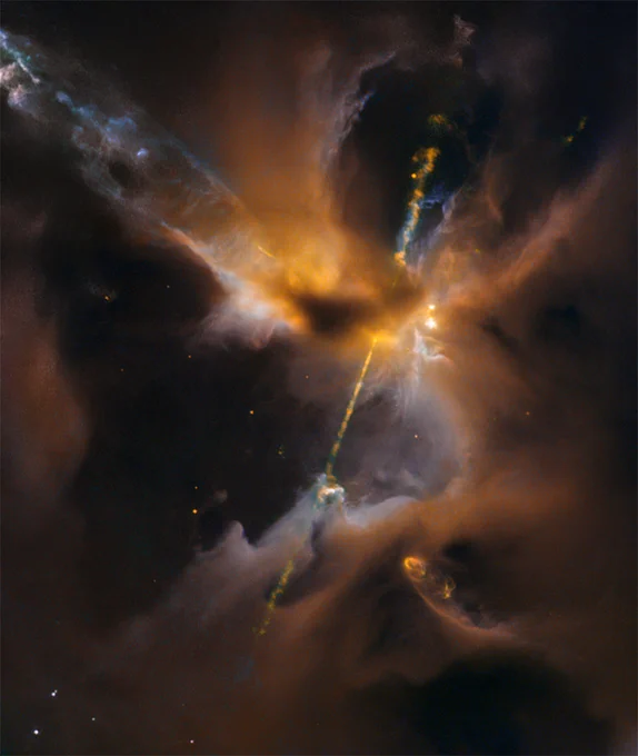 A cloudy region of space glows orange with the light of a jet arcing diagonally through the image.