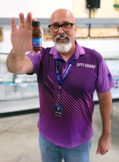 Michael LaVallee holds a bottle of our CyberSecure BBQ Sauce.
