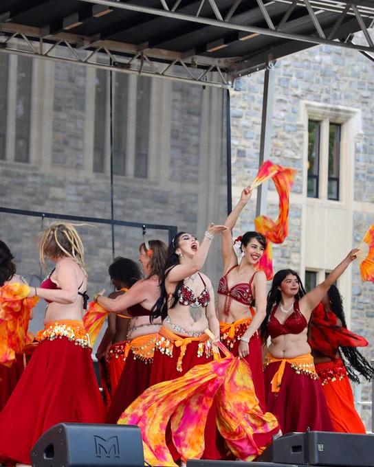 a group of people wearing traditional dress and performing