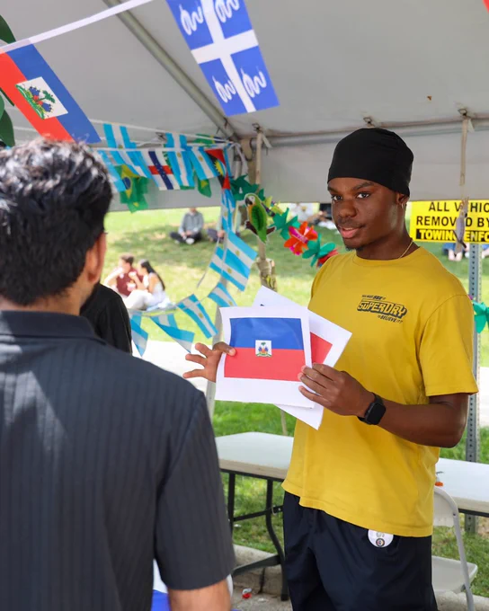 a man standing in front of a sign at his booth