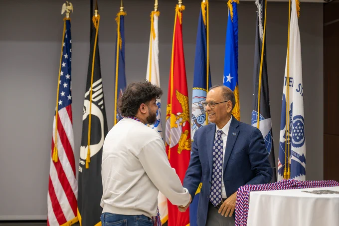 President Tripathi congratulates an honoree at UB's Veteran and Military Cord Celebration.