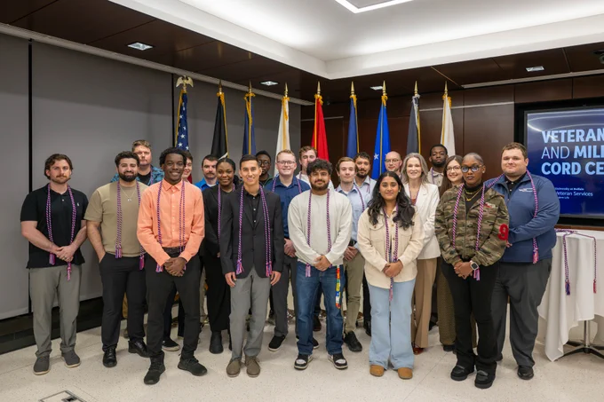 Participants pose for a group photo at UB's Veteran and Military Cord Celebration.