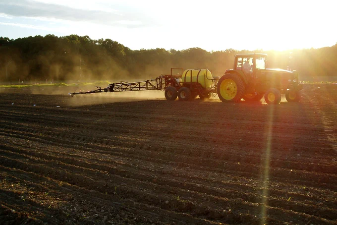 Herbicide application over corn at an experimental site, as part of a long-term study looking at herbicide losses after application. (Photo by ARS Researcher Joseph Alfieri).