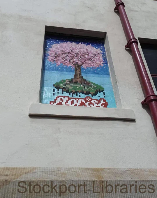 A window recess with a mosaic mural of a cheery tree with the word 'Florist'.