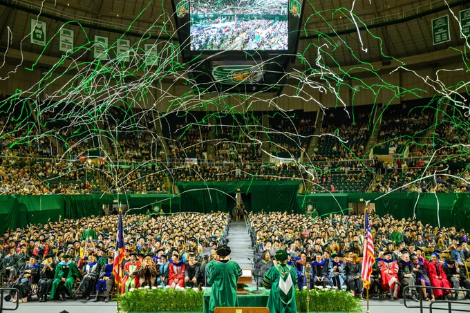 Confetti flies in the Convocation Center at the end of Commencement ceremony.