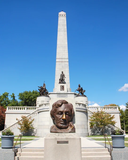A photo of Lincoln's tomb with a bust of Lincoln in the foreground.