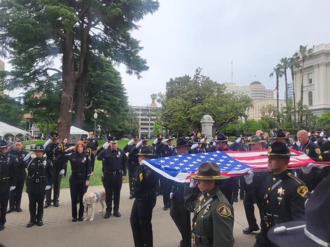 Peace officers carrying the US flag State at the State Capitol memorial ceremony for fallen state peace officers. 