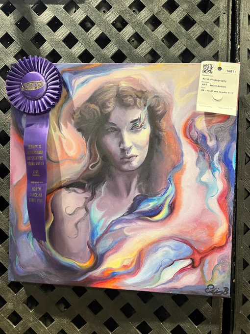 A watercolor image of a woman with a purple Grand Champion N.C. State Fair ribbon attached to it. 