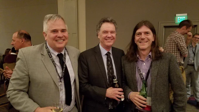 Three men smiling