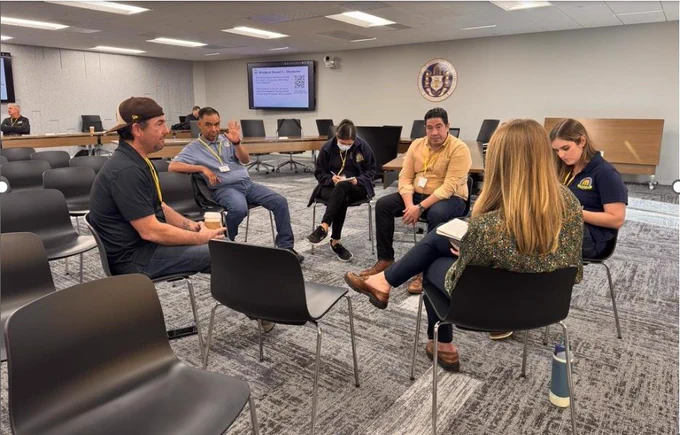  A small group discusses issues they’ve experienced with code implementation while CEC staff takes notes for its Energy Code Compliance Study.  

 