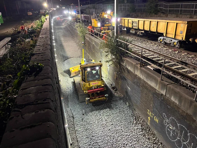 Night time working with yellow machines being used to create the new track bed at Primrose Hill.