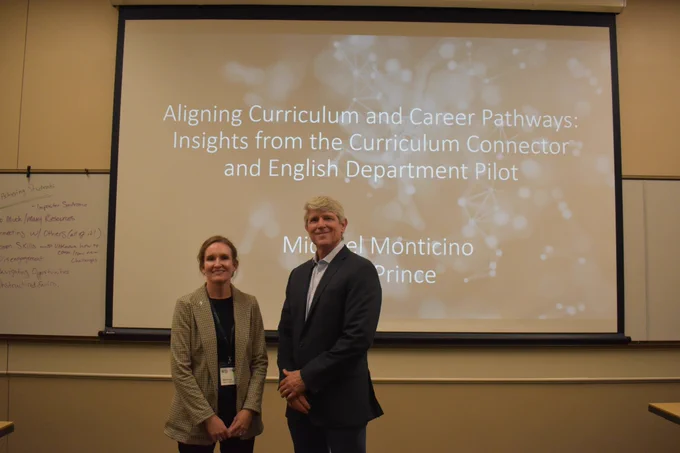 Curriculum Connector co-directors April Prince and Michael Monticino pose in front of their presentation 'Aligning Curriculum and Career Pathways: Insights from the Curriculum Connector and English Department Pilot'.