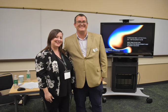 Teaching Hub community of practice leaders Stephanie Vastine and Brian Anderson pose in front of their presentation 'Engaging Ethical AI Integration'.