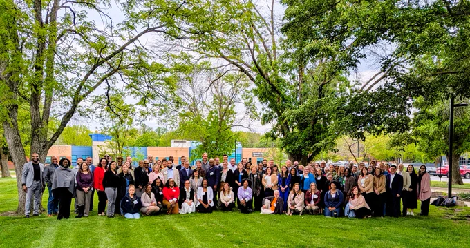 An outdoor group photo of the attendees of the 2026 SUCCESS Communities of Practice Convening at Lincoln Land Community College in Springfield