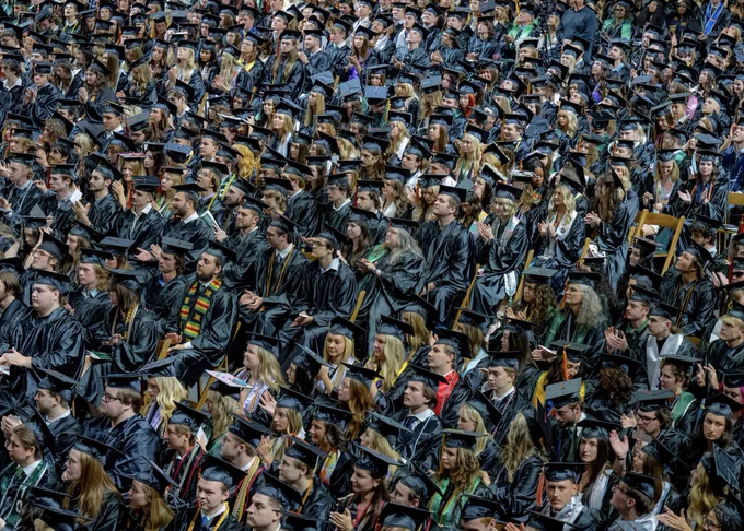 A sea of graduates seated at graduation. 
