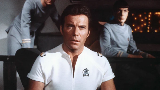 Admiral Kirk in a white short-sleeved uniform on the Enterprise bridge from Star Trek The Motion Picture. 