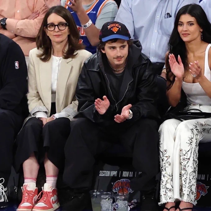 Trendy meme of Tina Fey, Timothee Chalamet and Kylie Jenner at basketball game shows different styles