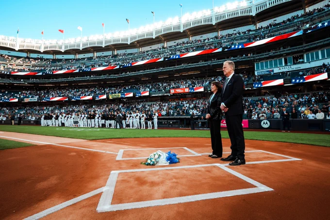 Suzyn Waldman and Michael Kay place flowers on home plate during a pregame tribute to John Sterling. 