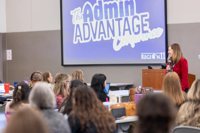 Dr. Lori Rapp is presenting to an audience at The Admin Advantage Conference, with a large screen displaying the event's name in the background.