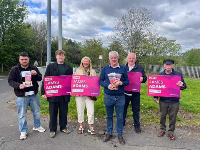 Campaigners with candidate James Adams holding placards and leaflets