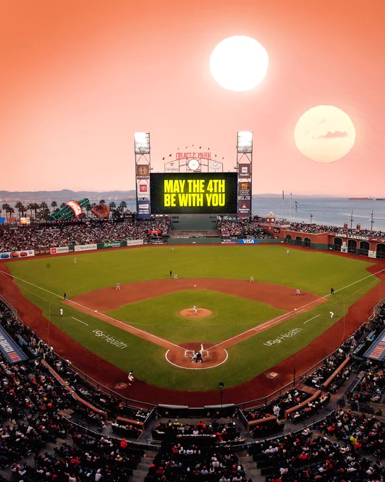 A manipulated image of Oracle Park in San Francisco at sunset. The Jumbotron reads: “MAY THE 4TH BE WITH YOU” in yellow font.