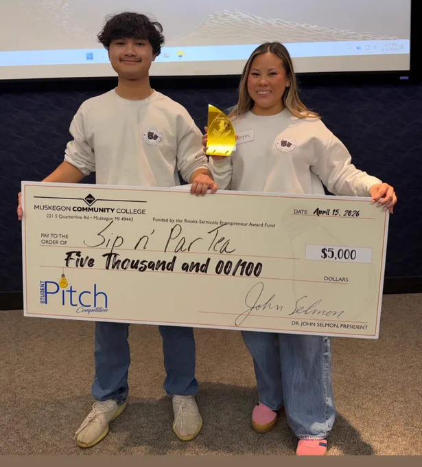 Kaden and Kayla posing with trophy and huge check image of $5000