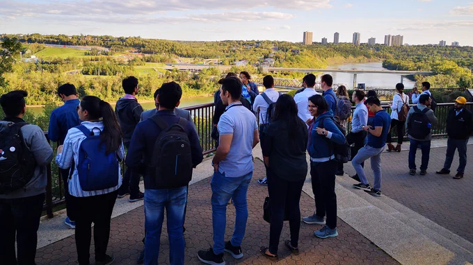 A group of people looking at the river valley