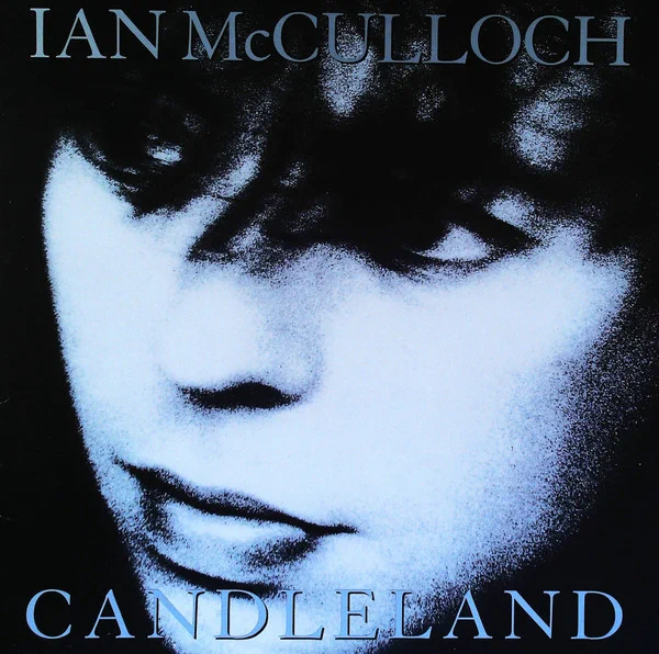 Ian McCulloch portrait from the Candleland album era 1989, close-up black and white image with soft blue tones, introspective expression and shadowed lighting.