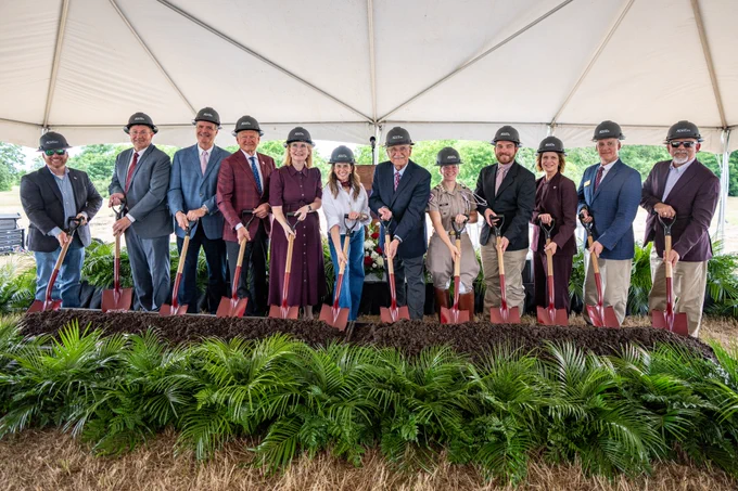 A group of people holding shovels during a grounbreaking ceremony.