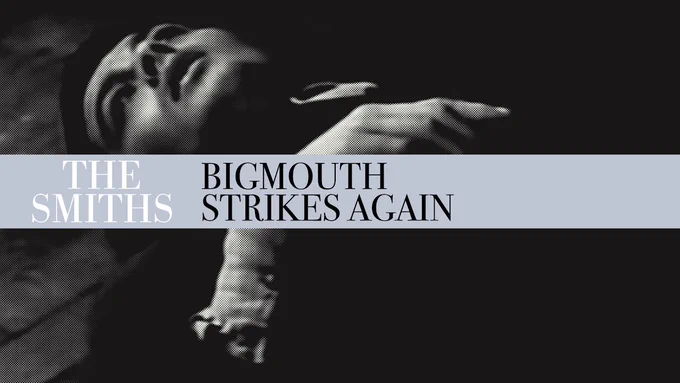 Black-and-white promotional artwork for The Smiths single “Bigmouth Strikes Again” (1986), featuring a dramatic reclining figure with high-contrast lighting and bold minimalist typography across the centre.