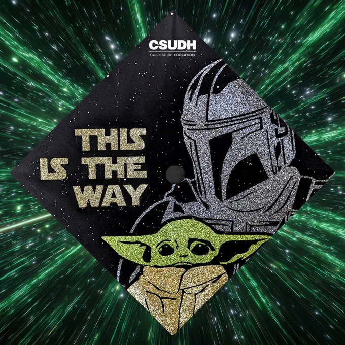 Graduation cap with The Mandalorian and Grogu with the phrase "This is the way." Green galaxy wormhole in the background. 