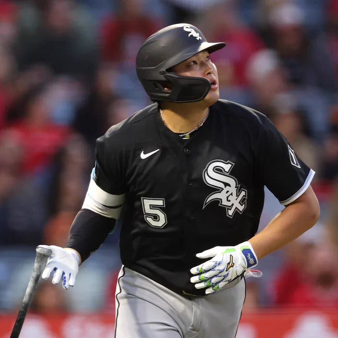 Munetaka Murakami drops his bat after hitting a home run. He wears a black White Sox jersey and a black helmet.