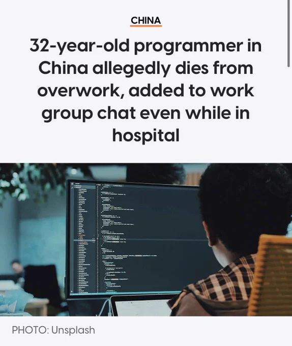 Headline about a 32-year-old Chinese programmer dying from overwork above a photo of a person viewing code on a large monitor in an office.