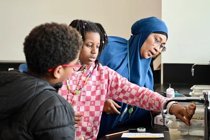 Teacher helps student with aquarium project