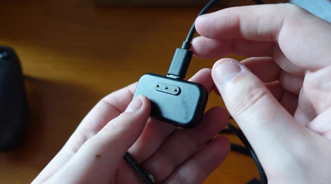 The wireless magnetic puck, with a USB-C cable plugged into it.
