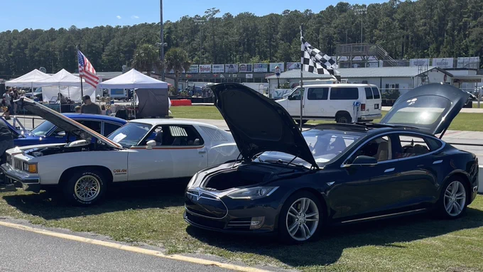 Sunday, May 3, 2026, Carteret County Speedway near Swansboro, NC.  Pictured left to right is a Cameo White 1977 Pontiac LeMans Can Am with its T/A 6.6 shaker hood and a Metallic Sequoia Green 2012 Model S.