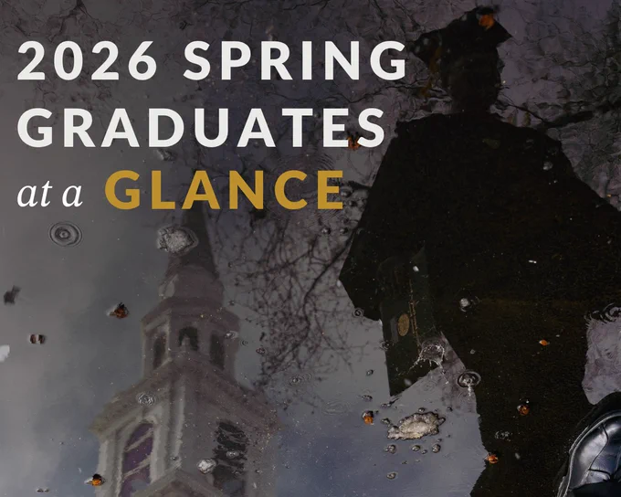 A reflective image of a college graduate in cap and gown with a clock tower mirrored in a puddle. The image conveys a sense of achievement and introspection.